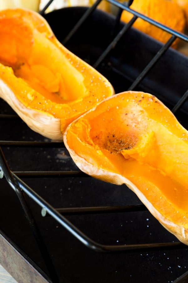 Roasted butternut squash with scooped out center on a roasting tray