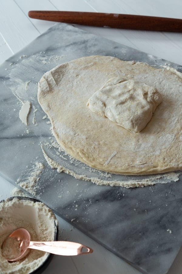 croissant dough rolled out with a square of butter in the middle of the dough