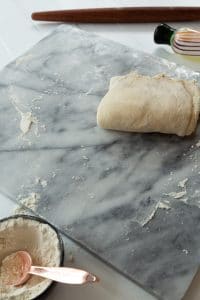 croissant dough rolled up into square