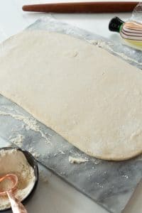 vegan croissant dough rolled out on marble