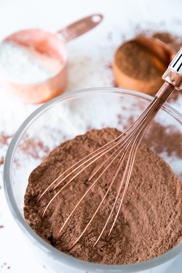 Whisking the dry ingredients of chocolate cake together with a whisk