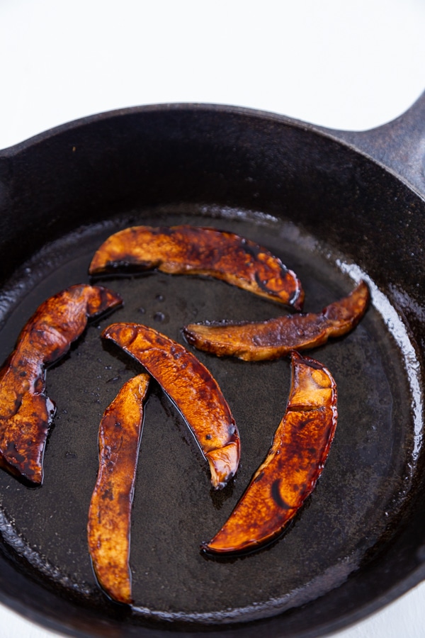 Mushroom bacon cooked in a cast-iron skillet