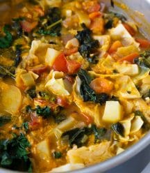 A pot of cabbage soup on a white table