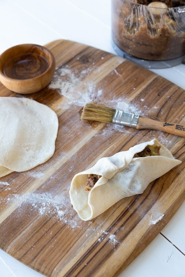 Folding the dough for empanadas 