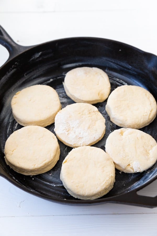 Round biscuits before baking in a cast-iron skillet