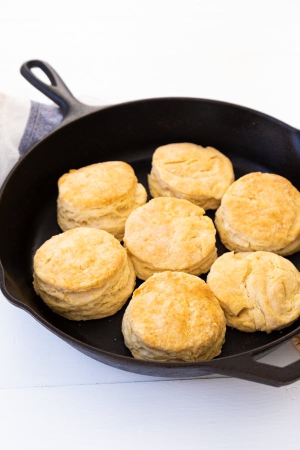 Golden brown baked biscuits in a black cast-iron skillet