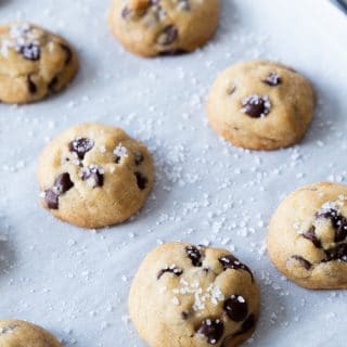 Chocolate chip cookies on a baking sheet with parchment paper