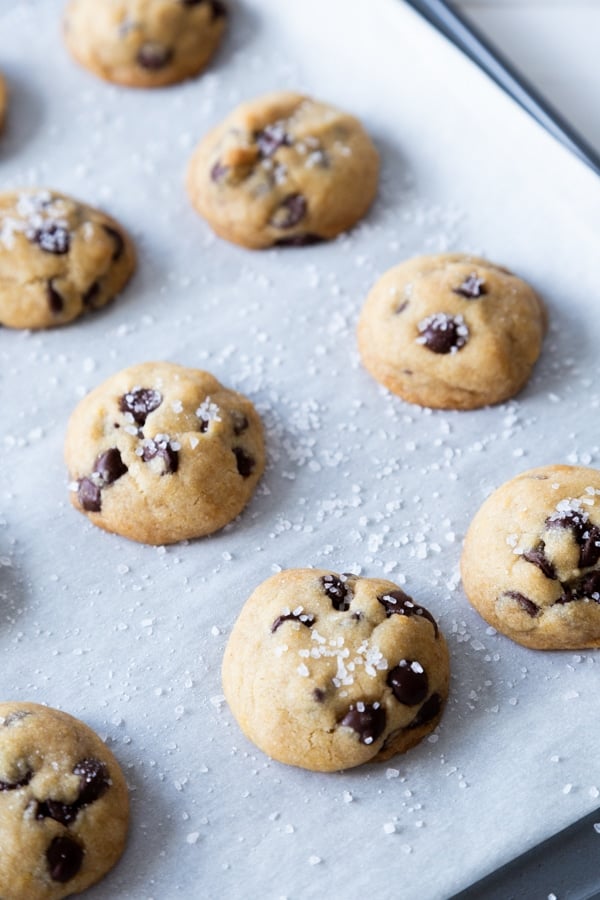 Chocolate chip cookies on a baking sheet with parchment paper