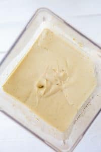 vegan cheesecake filling blended in a vitamix blender on a white board