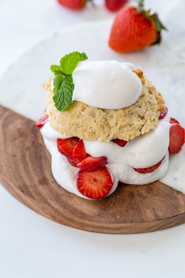 Strawberry shortcake on a marble and wood board.