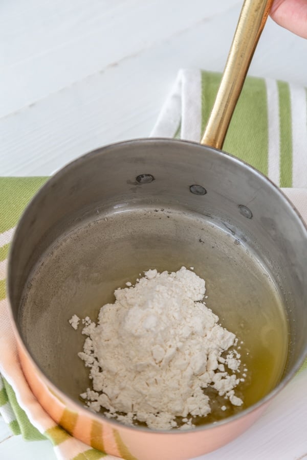 Flour and melted butter in a copper pan.