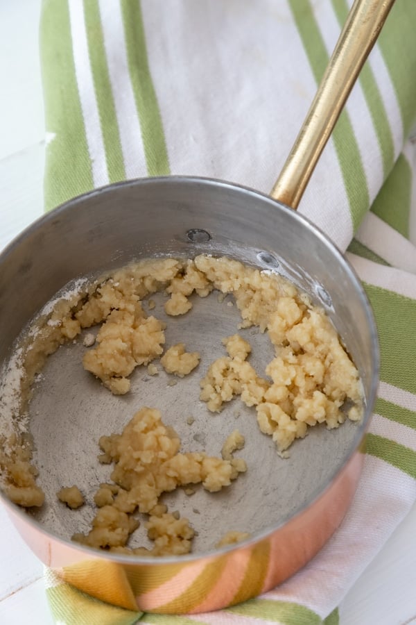 A copper pan with a roux.