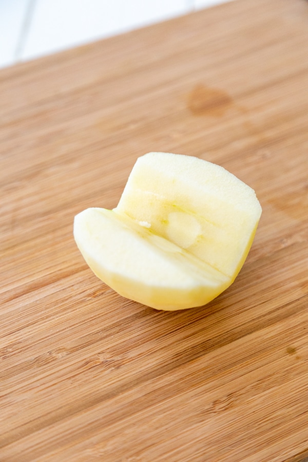 Half of a peeled and cored apple.