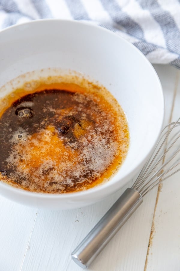 A white bowl of spices and oil. 