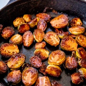 An iron skillet with roasted Brussels sprouts.