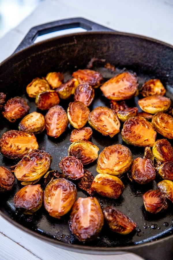 An iron skillet with roasted Brussels sprouts.