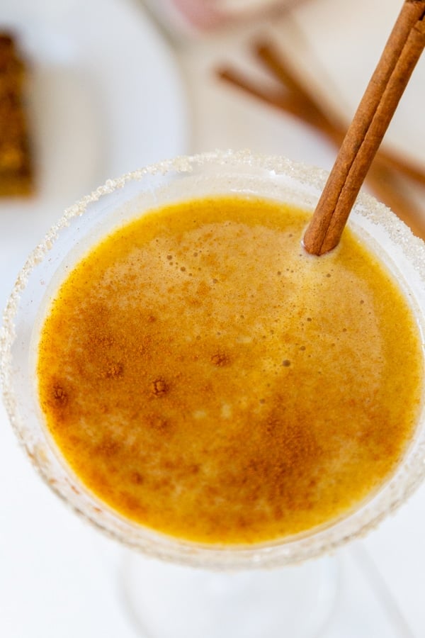 An overhead shot of a pumpkin martini with a cinnamon stick in the glass.