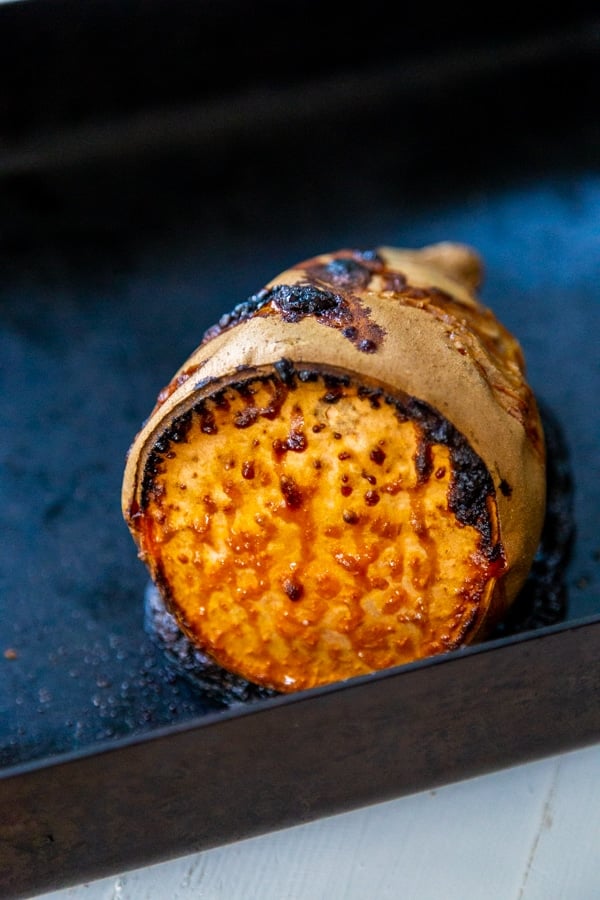 A roasted sweet potato with caramelized edges.