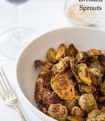 A white bowl of breaded Brussels sprouts with black text that says Maple Breaded Sprouts at the top right of the picture.