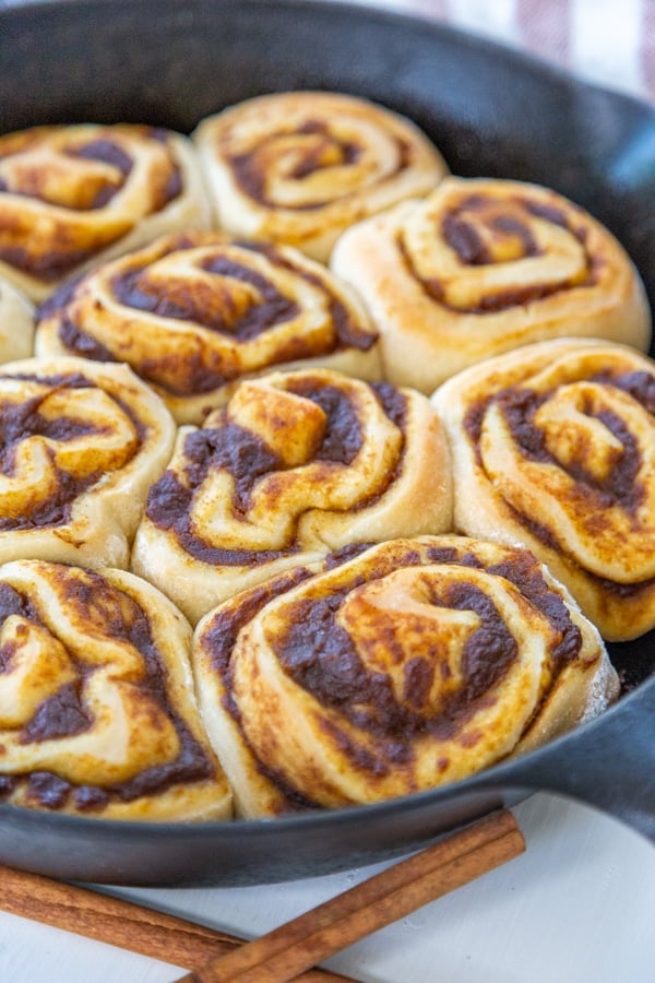 An iron skillet with freshly baked cinnamon rolls. 