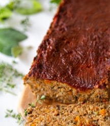 A lentil loaf with a slice of the loaf next to it.