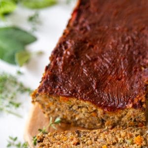 A lentil loaf with a slice of the loaf next to it.