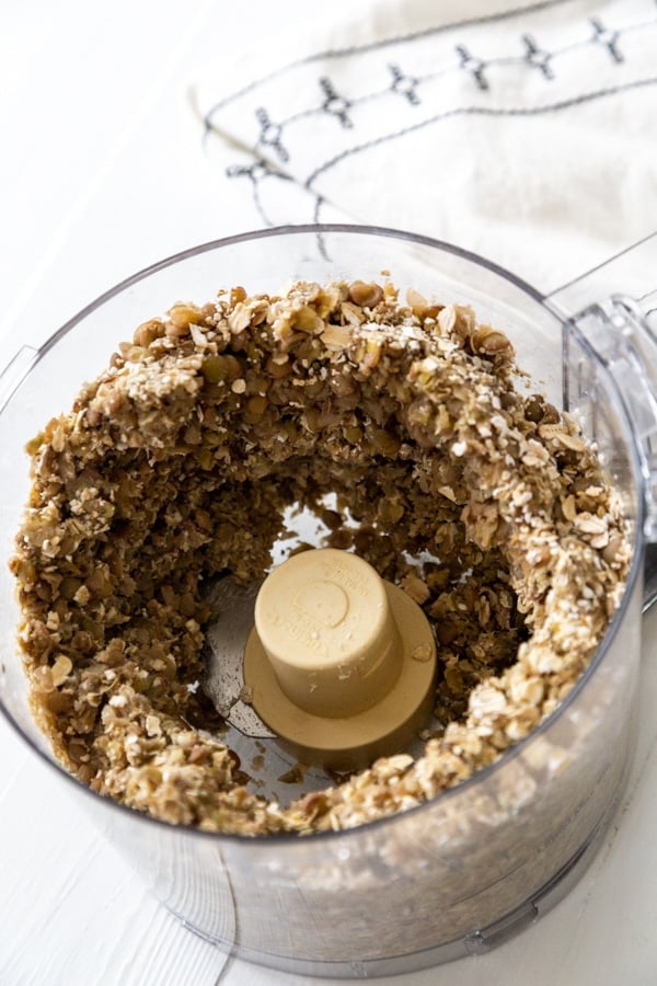 Ground oats and lentils in a food processor.