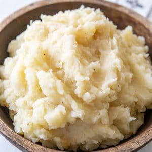Mashed potatoes in a wooden bowl.