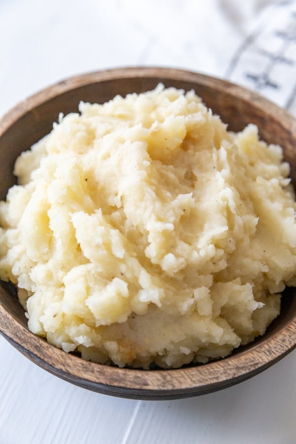 Mashed potatoes in a wooden bowl.