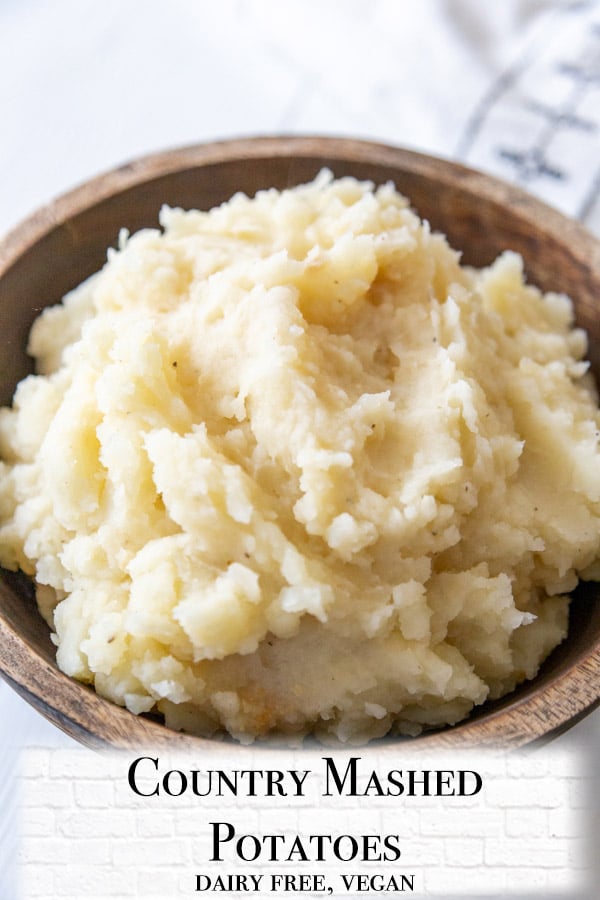 A Pinterest pin for mashed potatoes with a picture of the potatoes in a wooden bowl. 