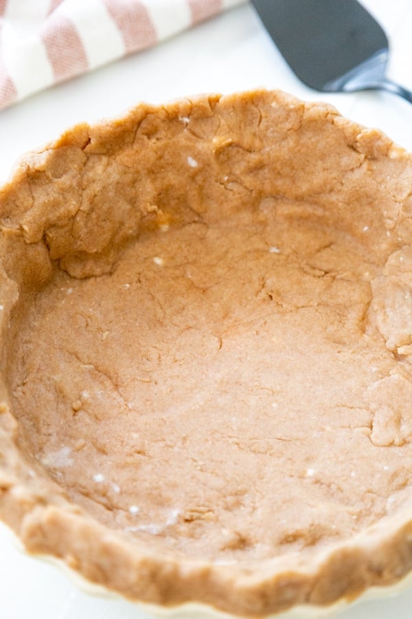 A baked pie crust shell in a pie pan. 