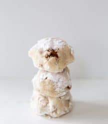 3 tea cake cookies stacked on top of each other on a white surface.
