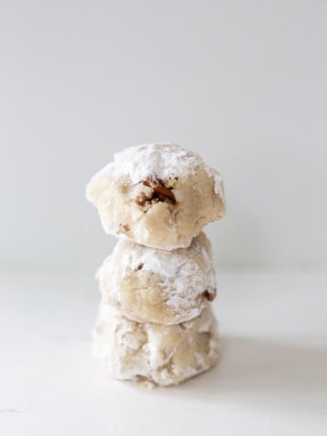 3 tea cake cookies stacked on top of each other on a white surface.