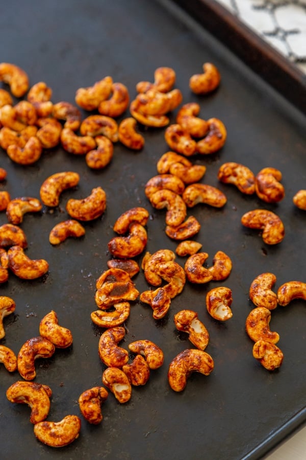 A baking sheet with roasted spiced nuts. 