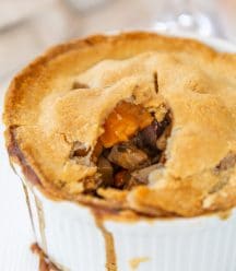 A vegetable pot pie with a piece taken out of the center.