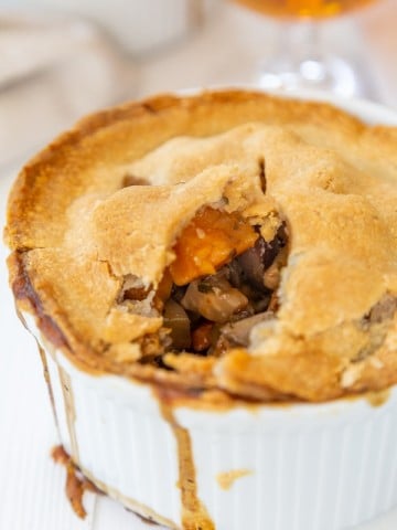 A vegetable pot pie with a piece taken out of the center.