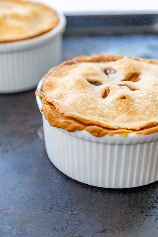 Two pot pies in white bowls. 