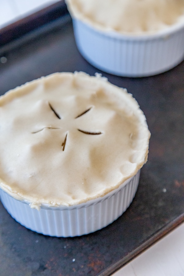 An uncooked pot pie with five slits in the pie dough.