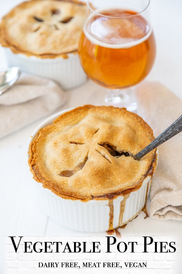 A Pinterest pin for vegetable pot pies with 2 pot pies and a beer in the picture. 