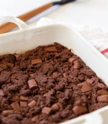 A white square dish with chocolate chunk brownies.