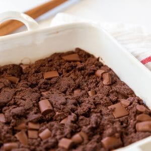A white square dish with chocolate chunk brownies.