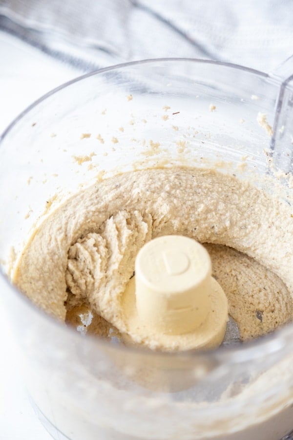 A food processor with creamy cashew cheese. 