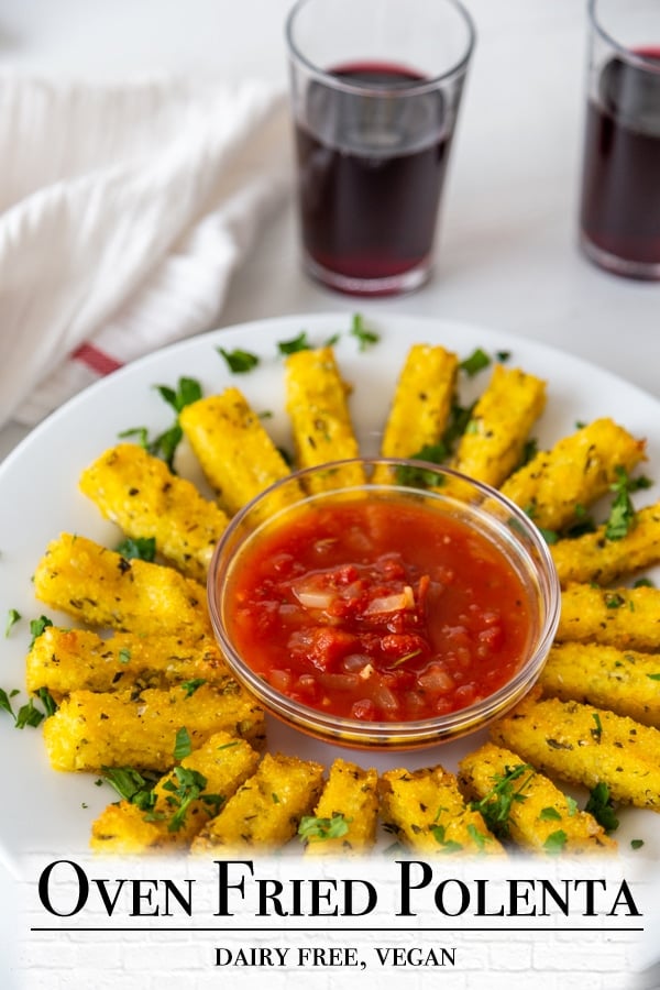 A Pinterest pin for vegan baked polenta fries with a picture of the fries and red sauce. 
