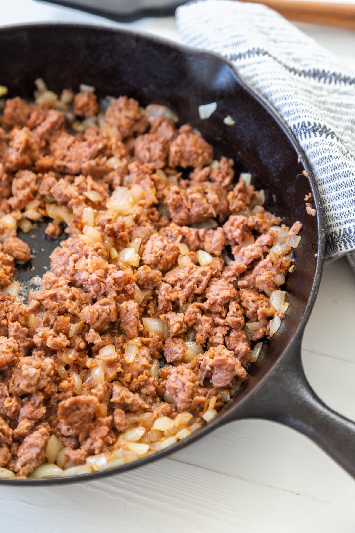An iron skillet with ground beef.