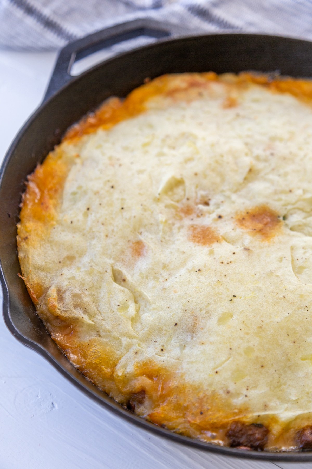 An iron skillet with vegan sheperd's pie.