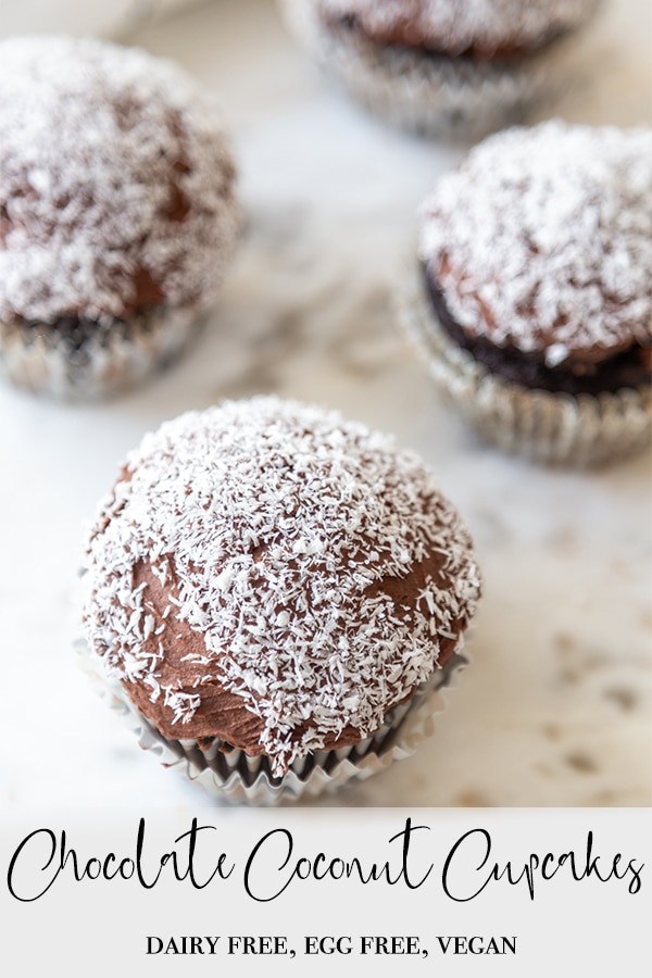 A Pinterest pin for vegan chocolate coconut cupcakes with a picture of the cupcakes on a marble board. 