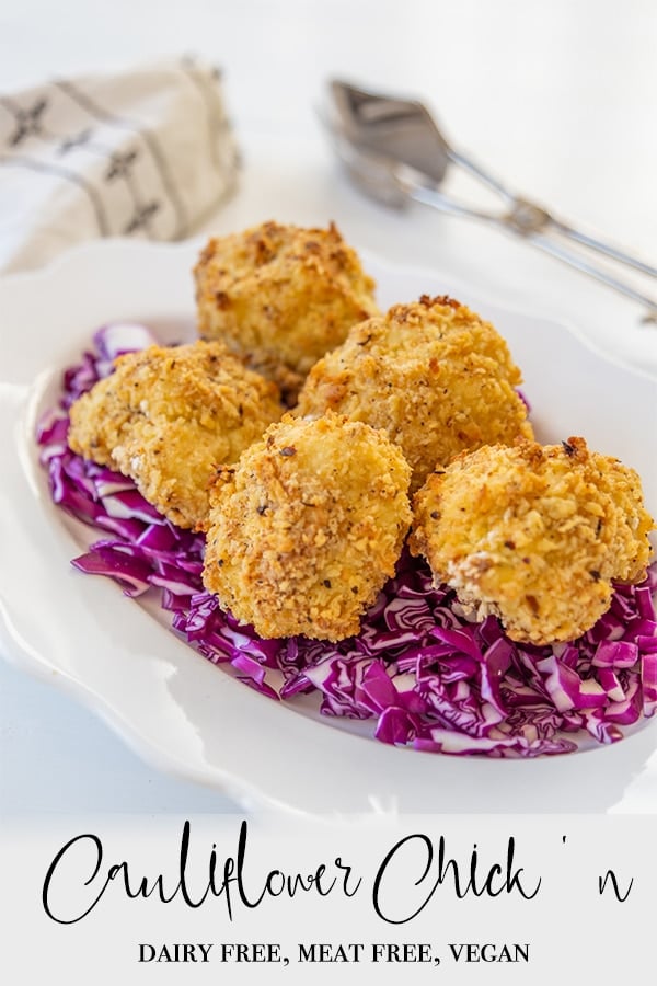 A PInterest pin for vegan oven fried cauliflower with a picture of the cauliflower on a bed of shredded cabbage on a white plate.