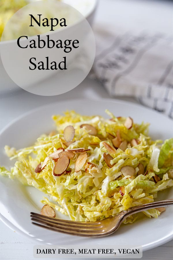 A Pinterest pin for Napa cabbage salad with a picture of the salad on a white plate with slivered almonds and a silver fork on the edge of the plate. 