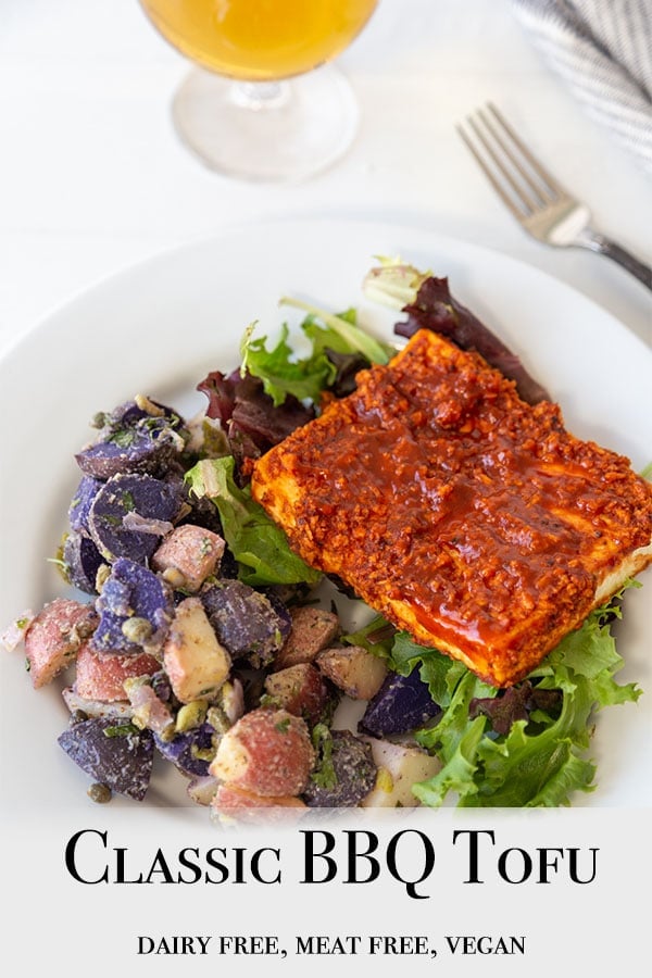 A Pinterest pin for Classic BBQ Tofu with a picture of the tofu and potato salad on a white plate. 