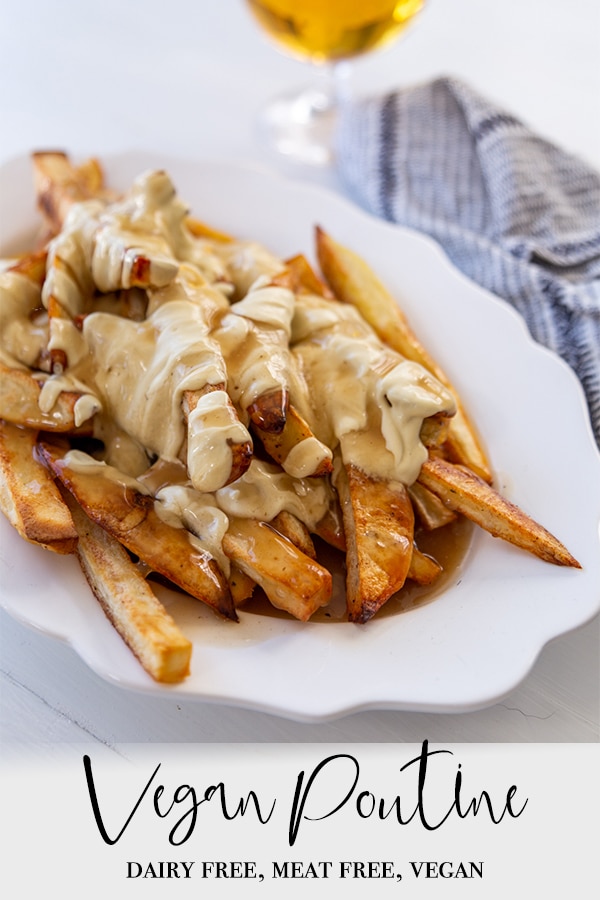 A Pinterest pin for vegan poutine with a picture of a white oval platter of the poutine and a glass of beer.